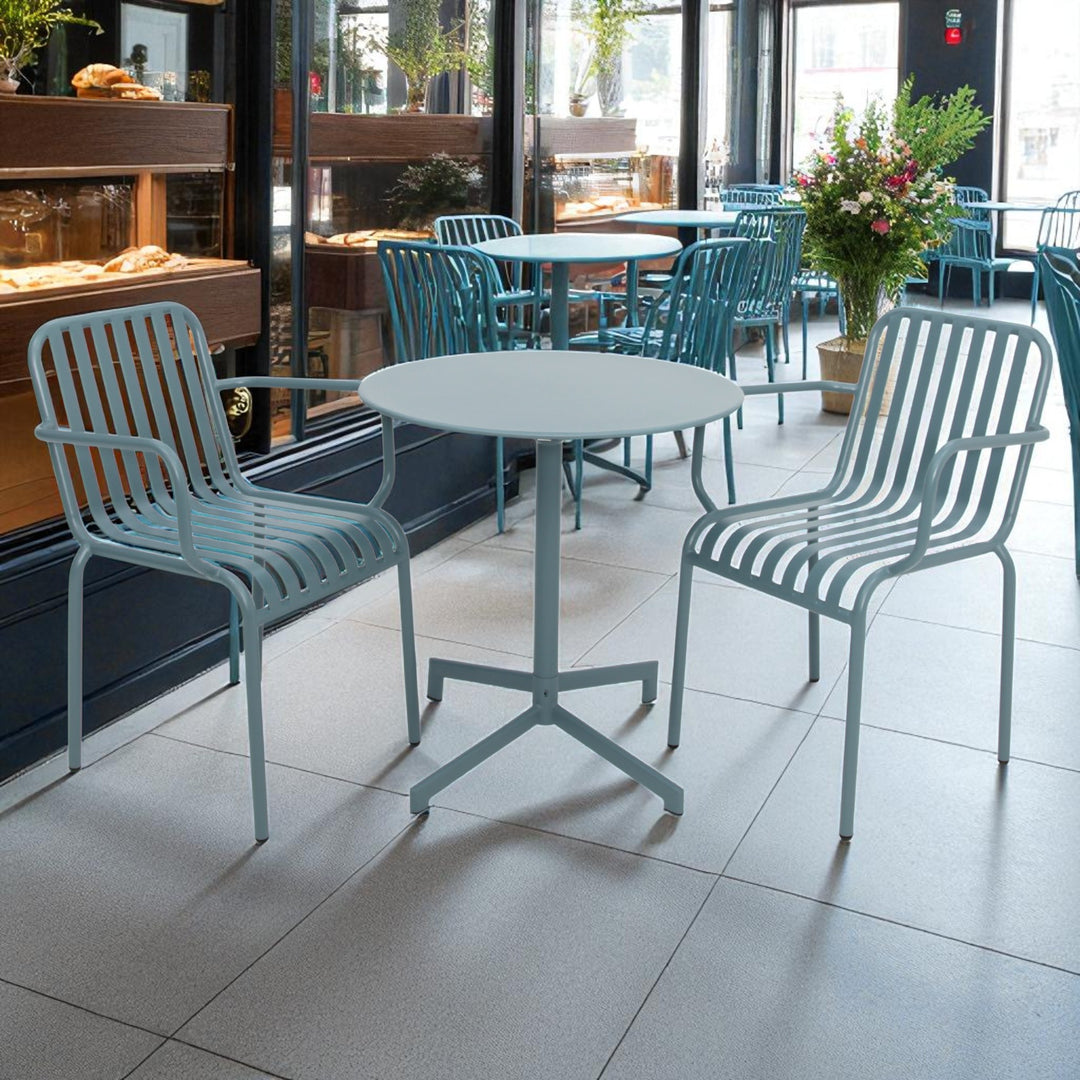Outdoor seating area with blue chairs and tables on a tiled floor.